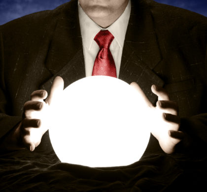 A businessman is consulting a crystal ball to foretell the future.